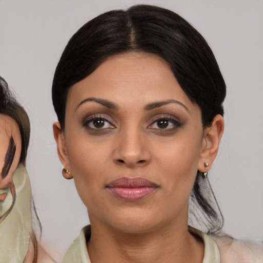 Joyful black young-adult female with medium  brown hair and brown eyes