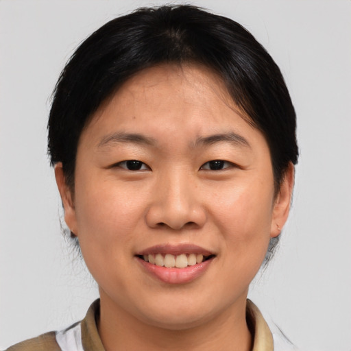 Joyful asian young-adult female with medium  brown hair and brown eyes