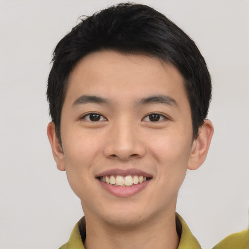 Joyful asian young-adult male with short  black hair and brown eyes