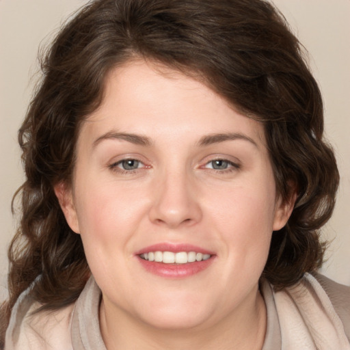 Joyful white young-adult female with medium  brown hair and blue eyes