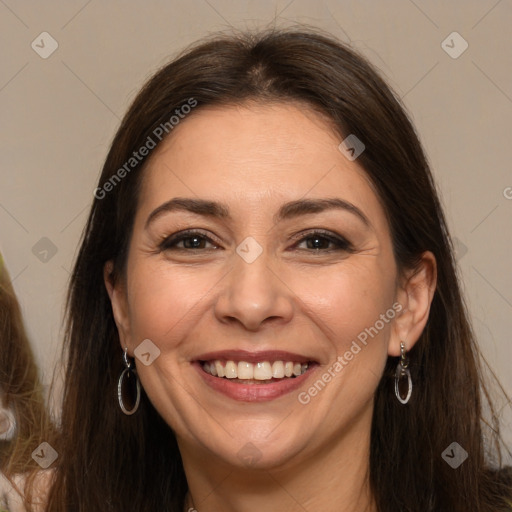 Joyful white adult female with long  brown hair and brown eyes