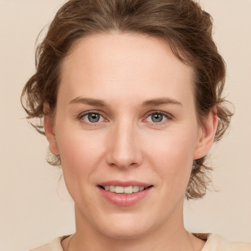 Joyful white young-adult female with medium  brown hair and green eyes