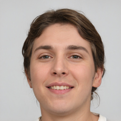 Joyful white young-adult male with medium  brown hair and brown eyes