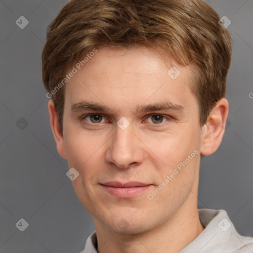 Joyful white young-adult male with short  brown hair and grey eyes