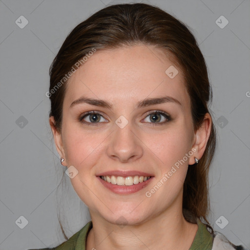 Joyful white young-adult female with medium  brown hair and blue eyes