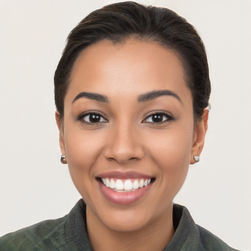 Joyful white young-adult female with long  brown hair and brown eyes