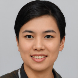 Joyful asian young-adult female with short  black hair and brown eyes