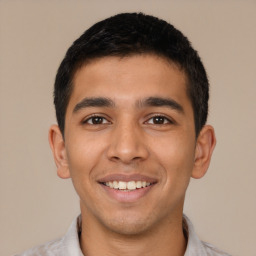 Joyful latino young-adult male with short  black hair and brown eyes