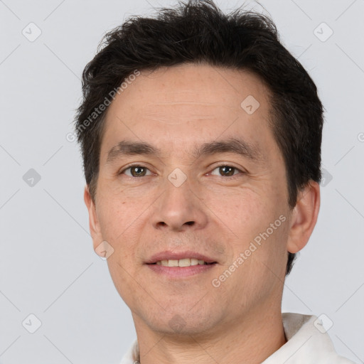 Joyful white adult male with short  brown hair and brown eyes