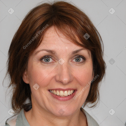 Joyful white adult female with medium  brown hair and blue eyes