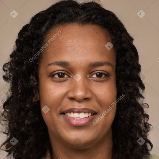 Joyful black young-adult female with long  brown hair and brown eyes