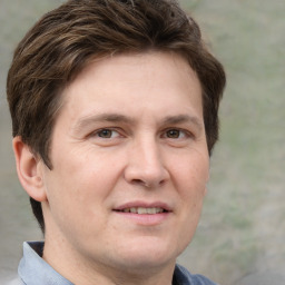 Joyful white adult male with short  brown hair and grey eyes