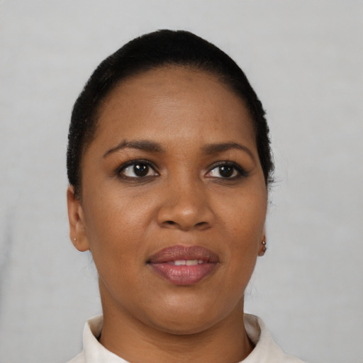 Joyful black young-adult female with short  black hair and brown eyes