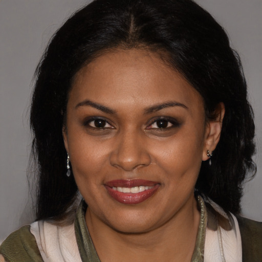 Joyful black young-adult female with medium  brown hair and brown eyes