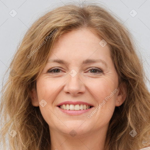 Joyful white adult female with long  brown hair and brown eyes