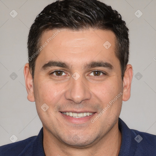 Joyful white young-adult male with short  black hair and brown eyes