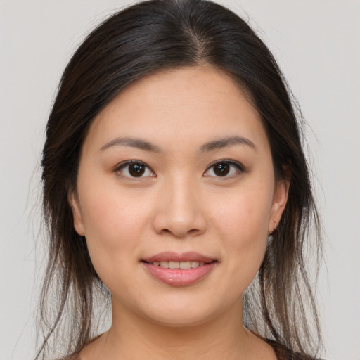 Joyful white young-adult female with long  brown hair and brown eyes