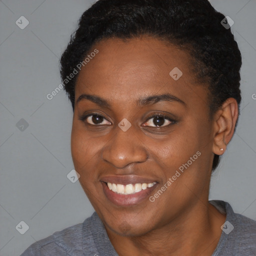 Joyful black young-adult female with short  black hair and brown eyes