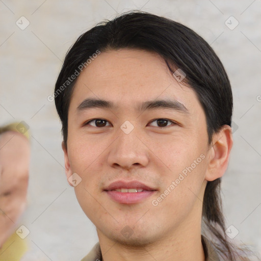 Joyful asian young-adult male with short  black hair and brown eyes