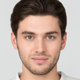 Joyful white young-adult male with short  brown hair and brown eyes