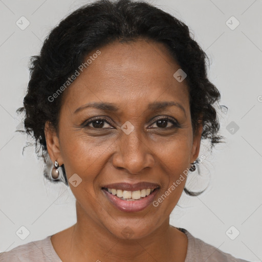 Joyful black adult female with short  brown hair and brown eyes