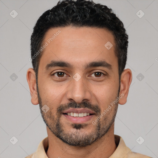 Joyful white young-adult male with short  black hair and brown eyes