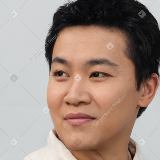 Joyful asian young-adult male with short  black hair and brown eyes