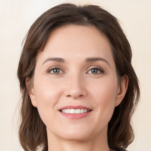 Joyful white young-adult female with medium  brown hair and brown eyes