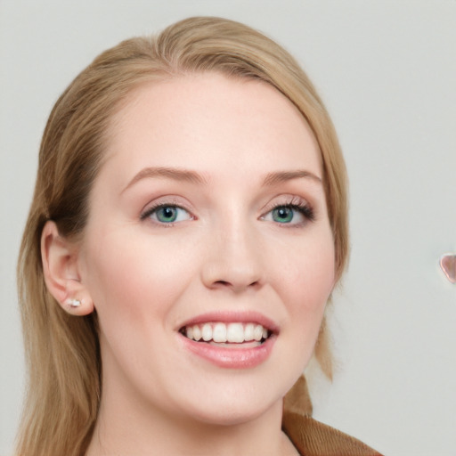 Joyful white young-adult female with long  brown hair and blue eyes