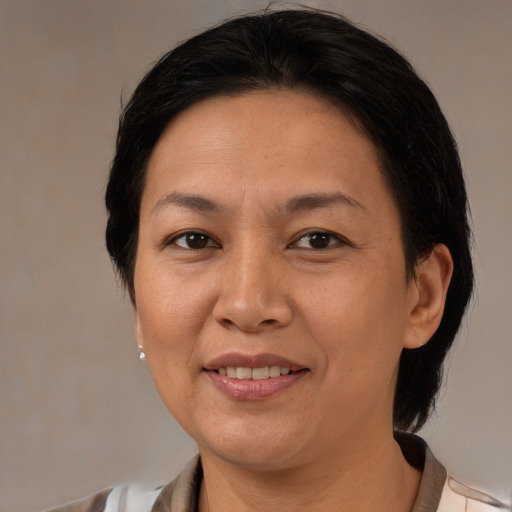 Joyful white adult female with medium  brown hair and brown eyes