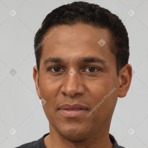 Joyful black adult male with short  black hair and brown eyes