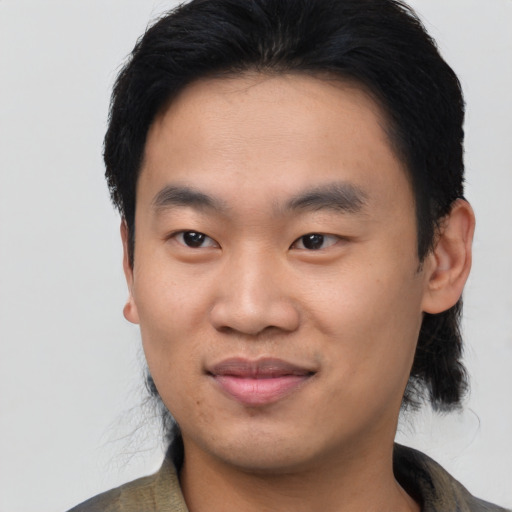 Joyful asian young-adult male with medium  black hair and brown eyes