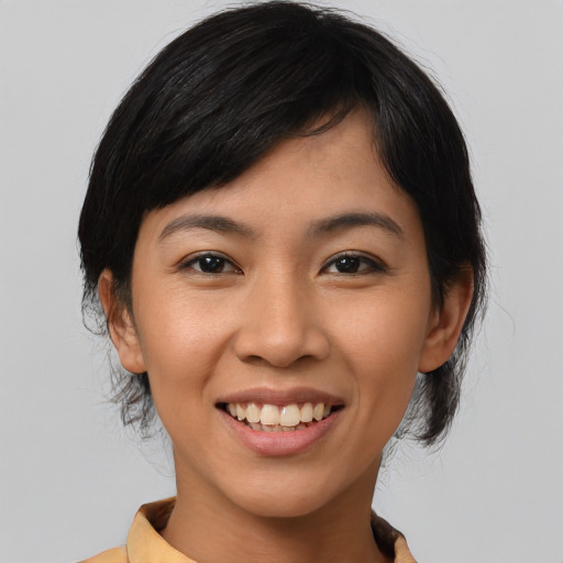 Joyful asian young-adult female with medium  black hair and brown eyes