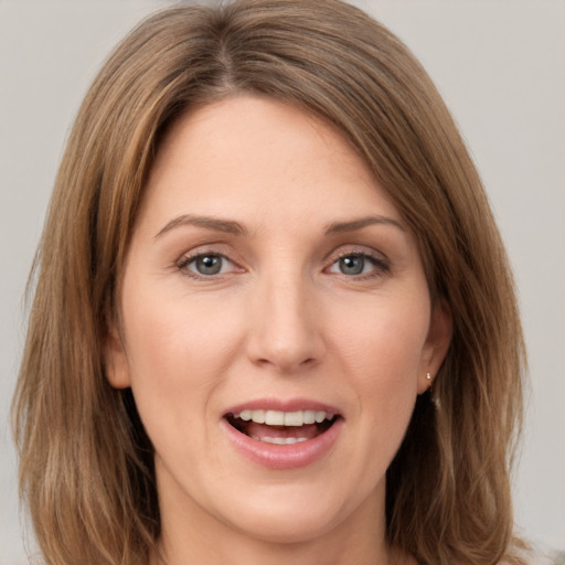 Joyful white young-adult female with long  brown hair and green eyes