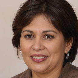 Joyful white adult female with medium  brown hair and brown eyes