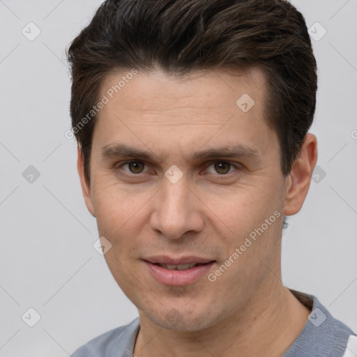 Joyful white adult male with short  brown hair and brown eyes