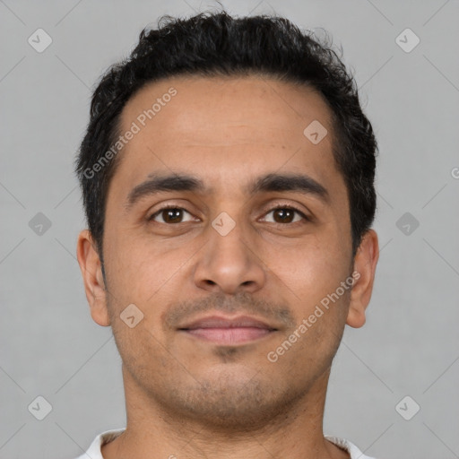 Joyful latino young-adult male with short  brown hair and brown eyes