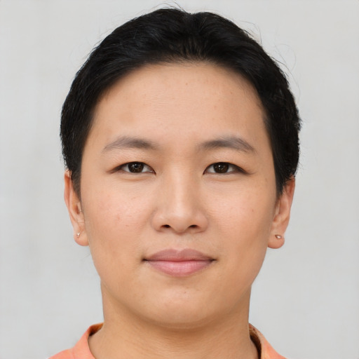 Joyful asian young-adult female with short  brown hair and brown eyes