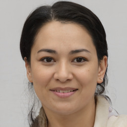 Joyful latino young-adult female with medium  brown hair and brown eyes