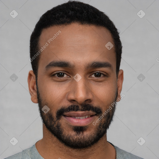 Joyful black young-adult male with short  black hair and brown eyes