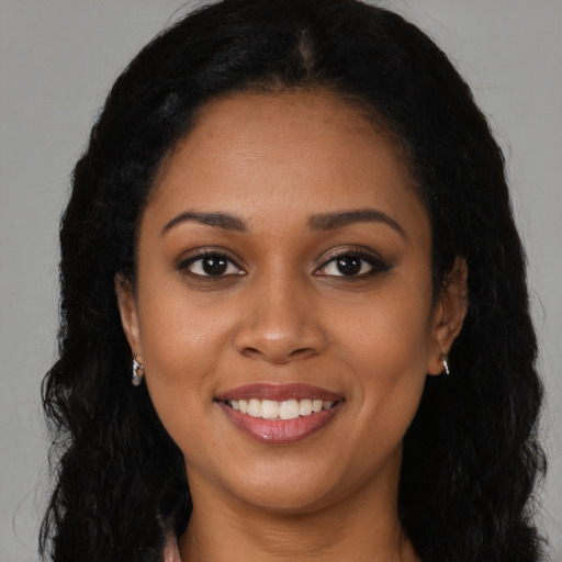 Joyful latino young-adult female with long  black hair and brown eyes