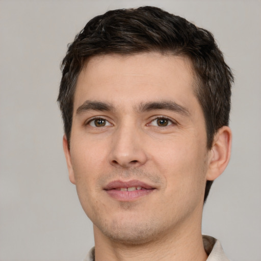 Joyful white young-adult male with short  brown hair and brown eyes