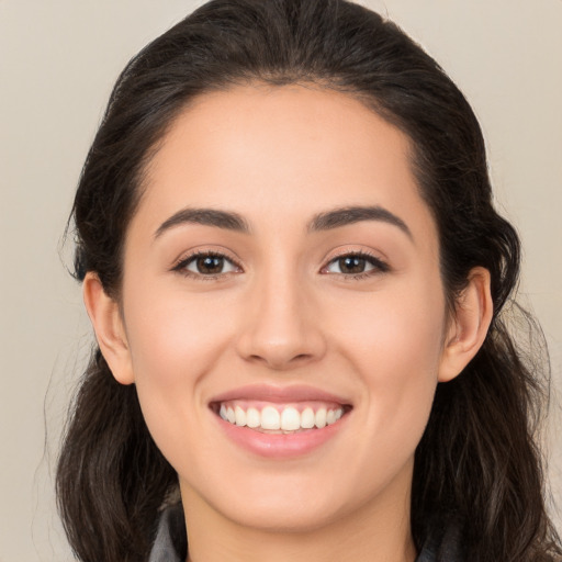 Joyful white young-adult female with long  brown hair and brown eyes