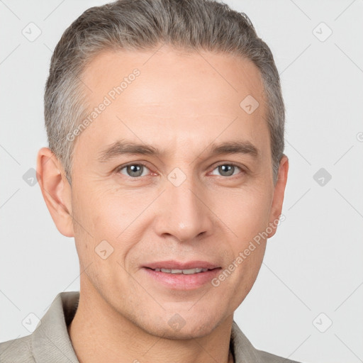 Joyful white adult male with short  brown hair and brown eyes