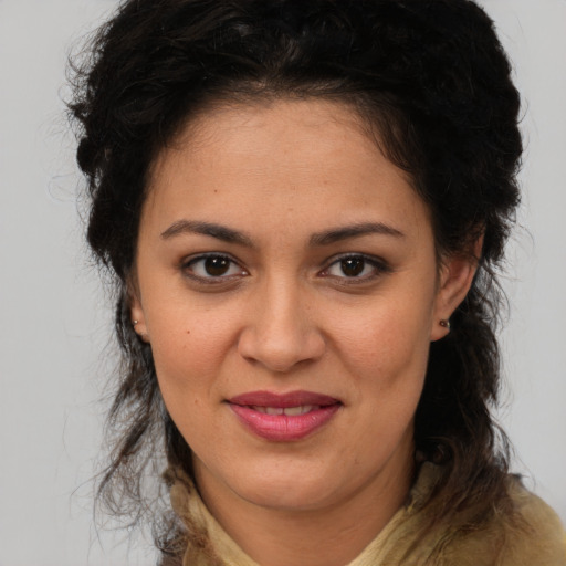 Joyful latino young-adult female with medium  brown hair and brown eyes