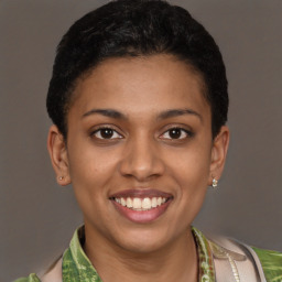 Joyful latino young-adult female with short  brown hair and brown eyes