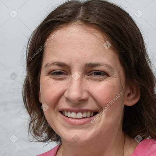 Joyful white adult female with medium  brown hair and grey eyes