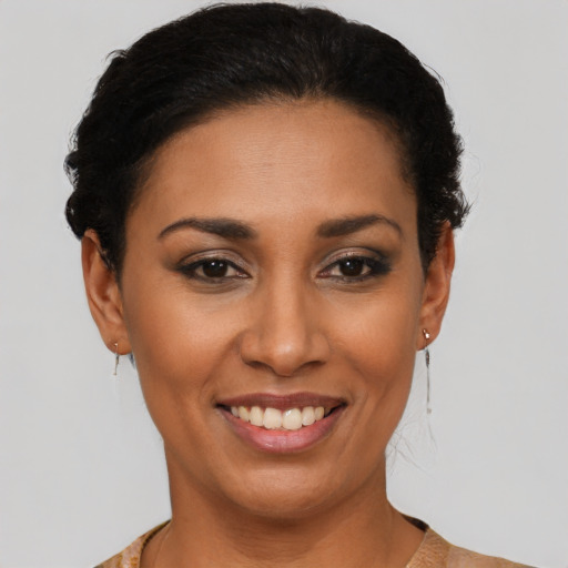 Joyful latino young-adult female with short  brown hair and brown eyes