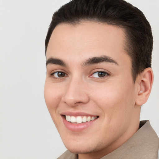 Joyful white young-adult male with short  brown hair and brown eyes