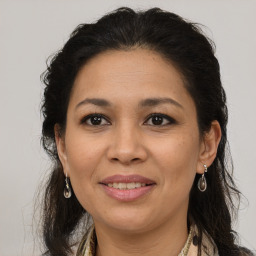 Joyful white adult female with long  brown hair and brown eyes